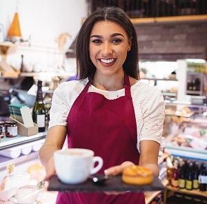 smiling woman serving coffee